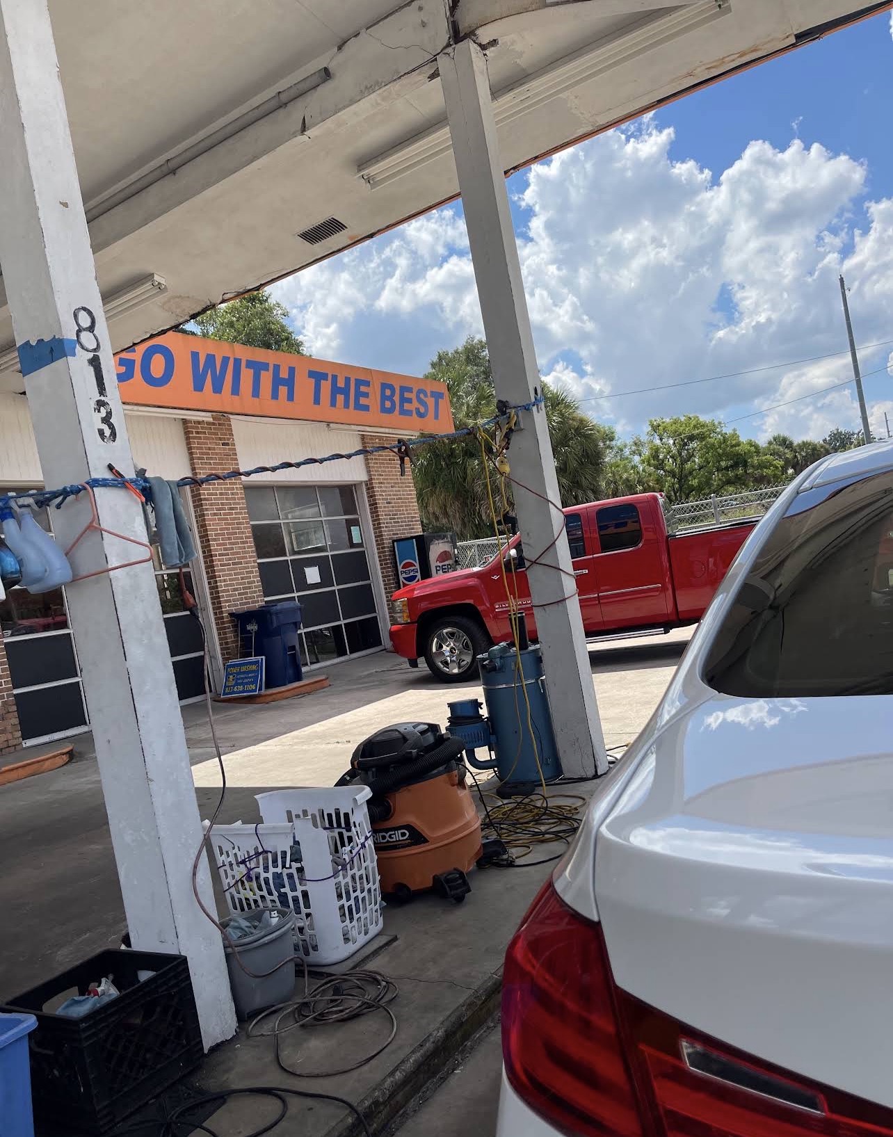 Mike's Pro Detailing shop exterior on E Sligh Ave in Seminole Heights, Tampa, with the orange 'Go With The Best' sign